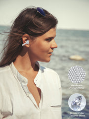 Woman wearing a diamond earring earphones with ocean background