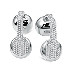 A pair of white gold clip-on earbuds with a diamond-like pattern on the surface.