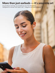 Woman wearing earbuds and earrings, holding a phone, with text about wearable art. earrings elegance and performance