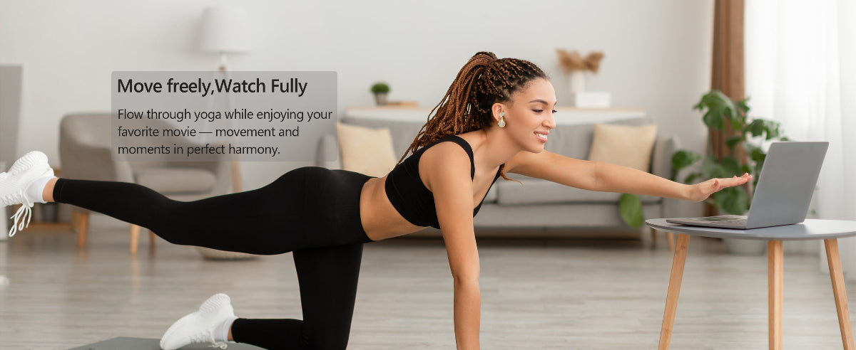 Woman exercising in a living room with a laptop on a table.