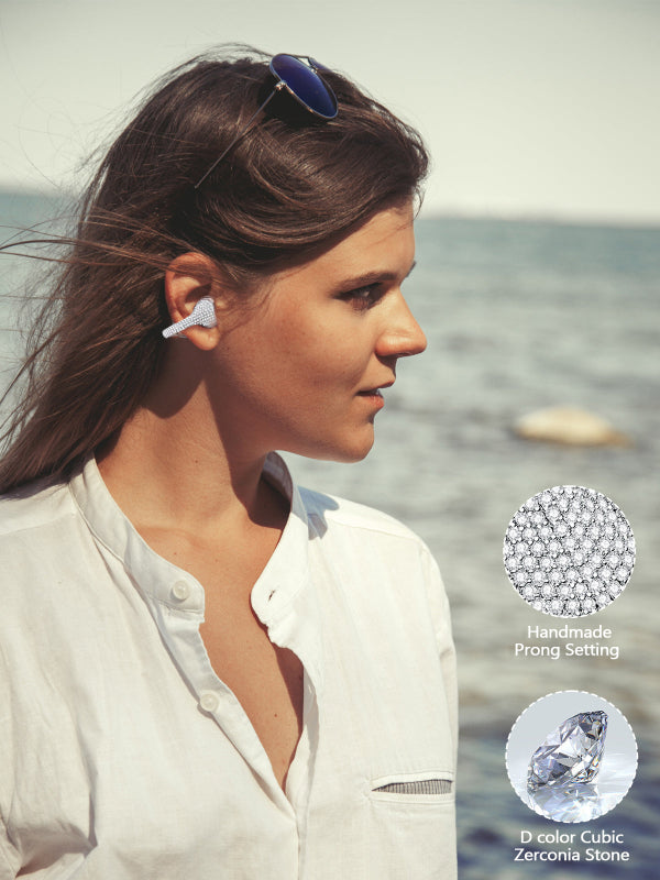 Woman wearing a diamond earring earphones with ocean background